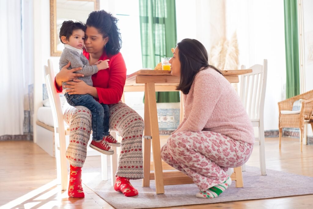 Parents comforting a toddler to build emotional safety and trust
