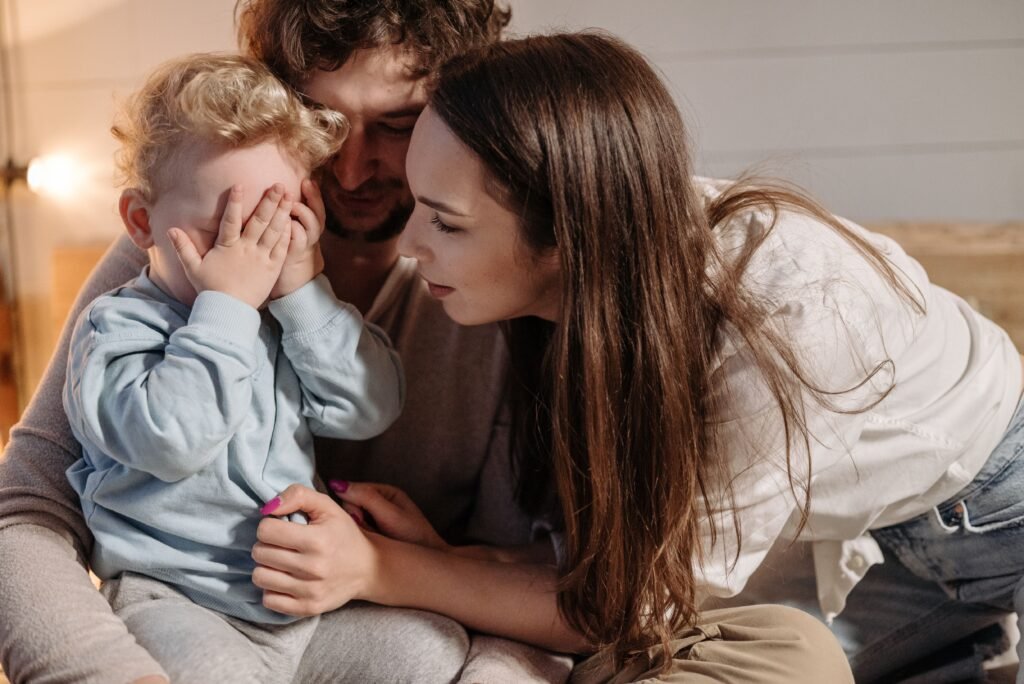 parents supporting emotional development in early childhood through comforting and conversation.
